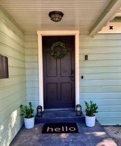 a door with a welcome mat in front of a house at Argo Häuschen in Alamo Heights in San Antonio