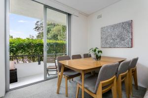a dining room with a wooden table and chairs at YNG03 - Cremorne - Young Street in Sydney