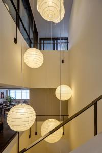 a group of lights hanging from the ceiling at Jiangnan House Chaozhou in Chaozhou