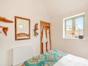 a bedroom with a bed and a window at The Pigeons Nest in Great Bolas