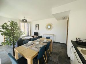 a kitchen and dining room with a wooden table and chairs at Appartement Calvi, 3 pièces, 4 personnes - FR-1-63-339 in Calvi