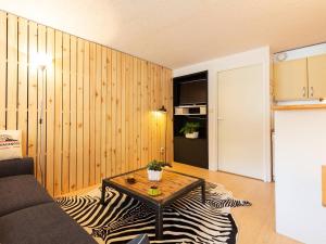 a living room with a couch and a table on a zebra rug at Studio 4 personnes avec balcon à Saint-Lary-Soulan - FR-1-296-477 in Saint-Lary-Soulan