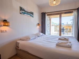 a bedroom with a bed and a window with a view at Appartement Huez, 2 pièces, 4 personnes - FR-1-645-40 in LʼHuez