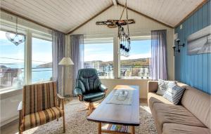 a living room with a couch and a chair at Nice Home In Bremnes With Wifi in Bremnes