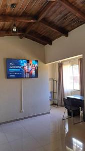 a living room with a flat screen tv on the wall at Casona Huascaran in Anta