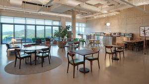 a large room with tables and chairs and a kitchen at The Heaven Island Resort in Ansan