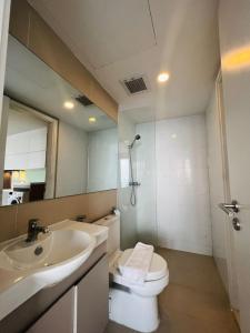 a bathroom with a sink and a toilet and a mirror at ImPian 1BR homestay in Phnom Penh
