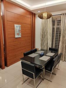 a dining room with a black table and black chairs at Nice semi D house at Tangkak in Tangkak