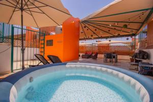 a swimming pool with umbrellas on a patio at New! Bamboo Rooftop (Jacuzzi & Fun) in Cuernavaca