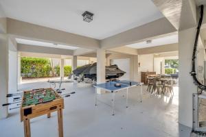 a living room with a table and a boat at Mojito Breeze Getaway home in Tavernier