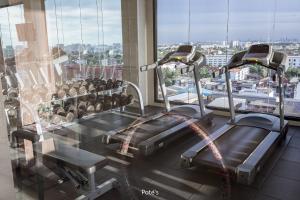 a gym with two tread machines in a building at 2BR Condo near DMK Airport/Joddfairs/Chatuchak in Ban Chuat Plai Mai