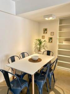 a white table with chairs and a bowl on it at Departamento en Palermo BA Flats in Buenos Aires