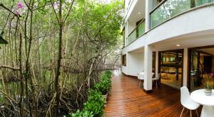 a house with trees and a wooden floor at Veneza Carioca Hotel Bout in Rio de Janeiro