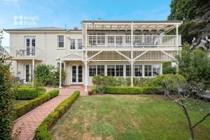 une grande maison blanche avec un jardin en face de celle-ci dans l'établissement Clydesdale Manor, à Hobart