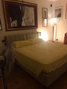 a bedroom with a bed and a picture on the wall at Dan House in Montefiascone