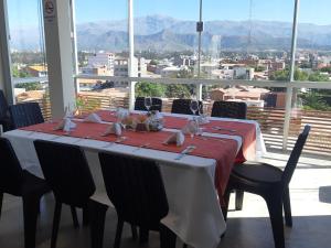 a dining room table with a red and white table cloth at Hotel Boutique Vendimia in Tarija