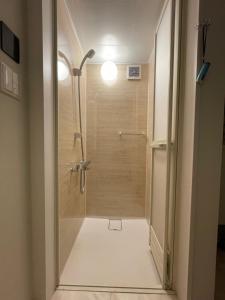a bathroom with a shower with a glass door at Boss'sHouse犬ok in Kirishima