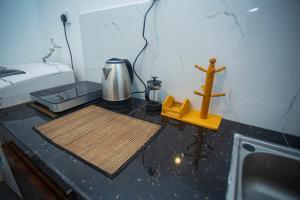 a room with a sink and a counter with a cross on it at Villa Beach Zone in Talpe