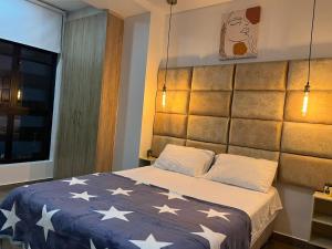 a bedroom with a bed with stars on it at Levits in Medellín