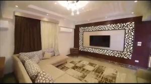 a living room with a couch and a flat screen tv at المهندسين خلف الاسواق الحره in Cairo