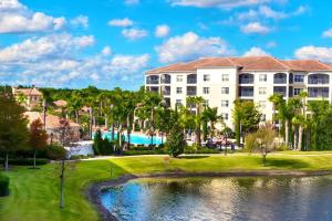 a view of a resort with a pool and a building at Entire Rental 3-BR Minutes from Disney x8 Hot tub in Orlando
