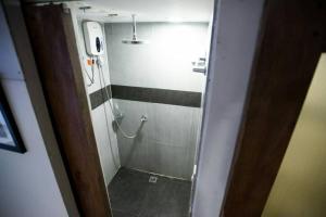 a small bathroom with a shower with a shower at Apartment Ground floor in El Nido