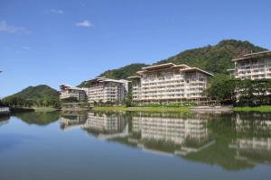 a row of apartment buildings next to a body of water at Family beach apartment with lagoon view at Pico de Loro in Nasugbu