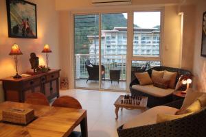 a living room filled with furniture and a large window at Family beach apartment with lagoon view at Pico de Loro in Nasugbu