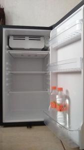 an open refrigerator with drinks and milk in it at Casita práctica, sencilla y lista para recibirte. in Silao