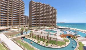 an aerial view of a resort pool with two tall buildings at Luxury Oceanview Condo - Las Palomas - Pool, Golf, Sandy Beach ! in Puerto Peñasco