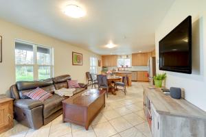 a living room with a couch and a tv at Lovely Soldotna Home, Steps From Kenai River in Soldotna