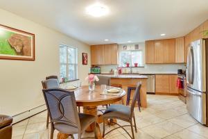 a kitchen with a table and chairs and a refrigerator at Lovely Soldotna Home, Steps From Kenai River in Soldotna