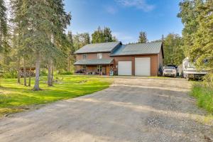 a large house with a garage and a driveway at Lovely Soldotna Home, Steps From Kenai River in Soldotna