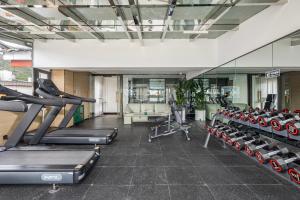 a gym with treadmills and cardio machines in it at kasion purey Designer Hotel - Lijiang Ancient City Sifang Street in Lijiang