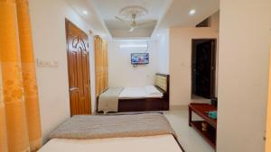 a small bedroom with a bed and a mirror at Hotel Prime Inn Mirpur 10 in Dhaka