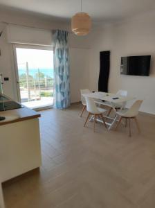 uma cozinha e sala de jantar com mesa e cadeiras em Stefanelli Tropea Home em Tropea