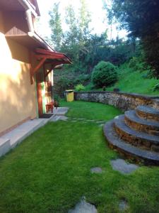 a garden with stairs and a stone wall at Chalupa Mlyn Dolný Kubín in Dolný Kubín