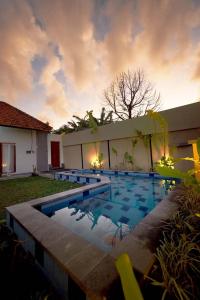 a swimming pool in the yard of a house at Umaditi Villa in Sanur