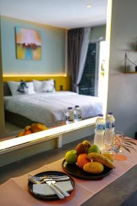une chambre d'hôtel avec une table et des fruits dans l'établissement Maiiam Bungalows Kata Beach, à Kata Beach