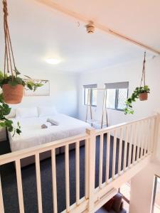 a bedroom with a bed and a staircase at YHA Byron Bay in Byron Bay