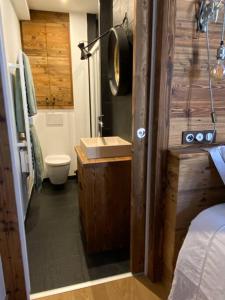 a bathroom with a sink and a toilet at Chalet de charme 190m2, La Lauzière, ski à pieds in Peisey-Nancroix
