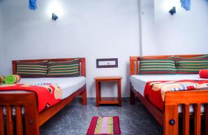 1 Schlafzimmer mit 2 Betten und einem Tisch mit Bettröcken in der Unterkunft Eco Diamond Palace in Ella