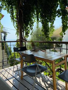 a wooden table and chairs sitting on a deck at Pinelopi Holiday House in Melínta