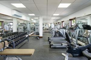 a gym with rows of treadmills and machines at Portico 3 by Blue Sky Luxury in Saint James