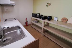 a kitchen with a sink and a counter at ホリデーハウス慈野(ジノ) in Takayama