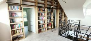 Pokój z półkami na książki wypełnionymi książkami w obiekcie Ranczo Bosikowo w mieście Kłyżówka
