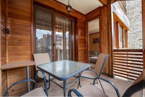 a dining room with a table and chairs on a porch at Peaceful Bansko Hideout in Bansko