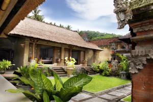 a house with a garden in front of it at Puri Bagus Manggis in Candidasa