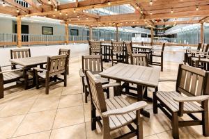 a restaurant with wooden tables and wooden chairs at Renaissance 908 in Myrtle Beach