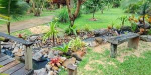 a park with a bench and a rock garden at Najjamee Bungalows in Ko Yao Noi